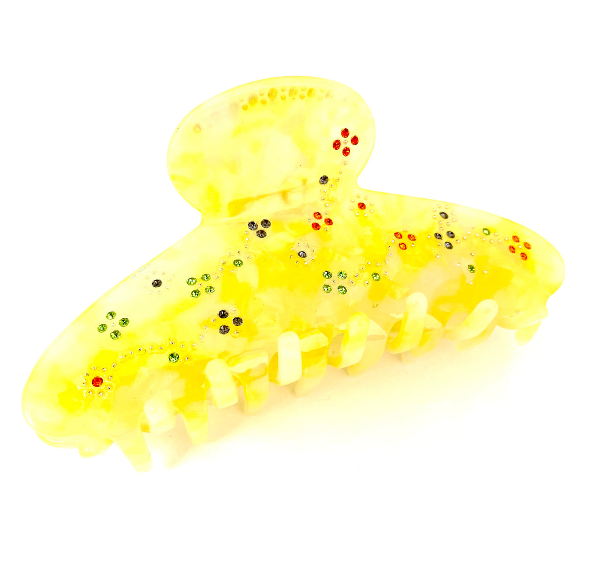 Stor hårklemme i gul marmoreret plast med en hel blomstereng i similisten